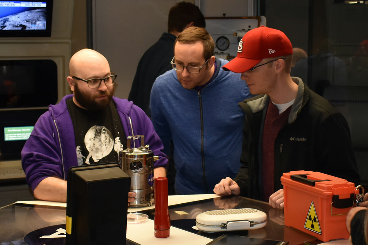 Group inspecting escape room items