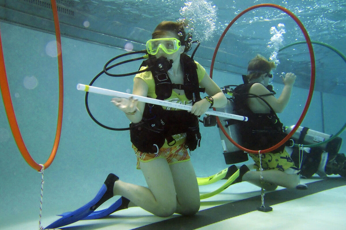 Group working underwater wearing scuba tanks