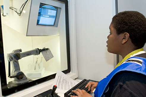 Child operating robot arm via computer