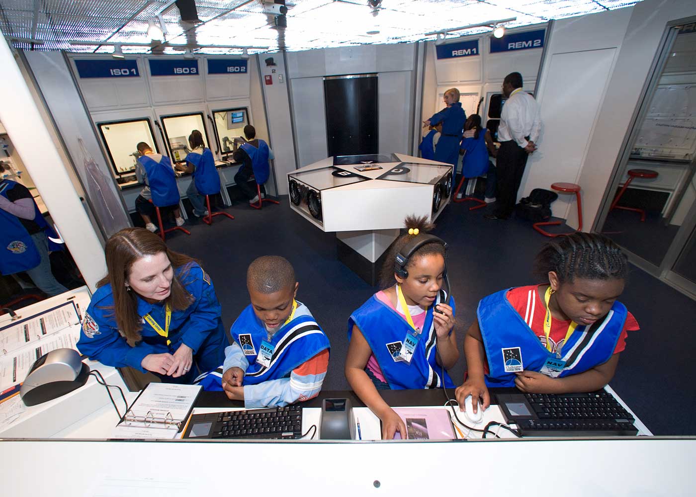 Group of children with instructor at mission control desk